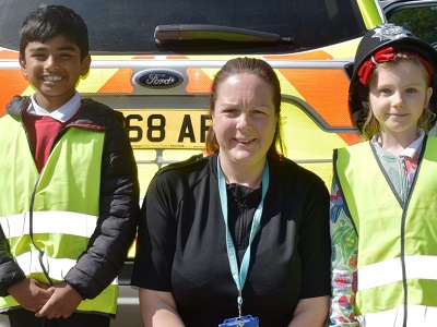 Two primary school children with PC Cheryl Claydon in the middle